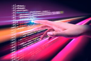 Programming course concept showing computer code on a digital screen being operated by touch